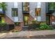 Modern townhouse exterior with brick and metal accents, landscaped front yard, and striking architectural details at 414 Chavis Way, Raleigh, NC 27601
