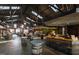 Spacious interior of Transfer Co. Food Hall with metal ceiling and exposed beams at 414 Chavis Way, Raleigh, NC 27601