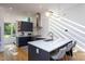 Bright kitchen features navy cabinets, quartz countertops, stainless appliances, and pendant lighting at 414 Chavis Way, Raleigh, NC 27601