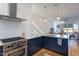 Well-appointed kitchen with stainless steel appliances, white subway tile, and navy base cabinets at 414 Chavis Way, Raleigh, NC 27601
