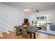 Inviting living area connected to dining shows hardwood floors, modern lighting, and neutral colors at 414 Chavis Way, Raleigh, NC 27601
