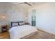 Comfortable main bedroom featuring neutral tones, wall sconces, ceiling fan, and a glimpse of the ensuite bathroom at 414 Chavis Way, Raleigh, NC 27601