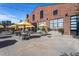 Outdoor patio with tables, chairs and yellow umbrellas at Transfer Co. Food Hall at 414 Chavis Way, Raleigh, NC 27601