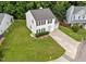 Aerial view of home featuring a driveway and green lawn at 4221 Ivy Hill Rd, Raleigh, NC 27616