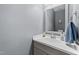Neutral powder room with modern vanity, a framed mirror, and towel bar at 4221 Ivy Hill Rd, Raleigh, NC 27616