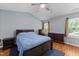 Comfortable bedroom with vaulted ceiling, hardwood floors, and natural light at 4221 Ivy Hill Rd, Raleigh, NC 27616