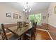 Inviting dining room features modern lighting, a large window, and beautiful hardwood floors at 4221 Ivy Hill Rd, Raleigh, NC 27616
