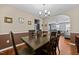 Bright dining room offering hardwood floors and a view to the living room through an arched opening at 4221 Ivy Hill Rd, Raleigh, NC 27616