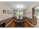 Traditional dining room with hardwood floors, decorative chandelier, and large window at 4221 Ivy Hill Rd, Raleigh, NC 27616