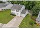 A well maintained two story house with an attached single car garage and a yard at 4221 Ivy Hill Rd, Raleigh, NC 27616