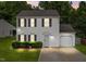 Charming two-story home featuring a well-manicured lawn, attached garage, and white siding at 4221 Ivy Hill Rd, Raleigh, NC 27616
