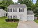 Charming two story house with black shutters, an attached garage and manicured landscaping at 4221 Ivy Hill Rd, Raleigh, NC 27616