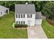 Charming two-story home with a well-manicured lawn, attached garage, and traditional architectural details at 4221 Ivy Hill Rd, Raleigh, NC 27616