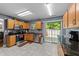 Updated kitchen featuring stainless steel appliances, black countertops and wood cabinetry and sliding glass doors at 4221 Ivy Hill Rd, Raleigh, NC 27616