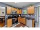 Updated kitchen featuring stainless steel appliances, black countertops and wood cabinetry at 4221 Ivy Hill Rd, Raleigh, NC 27616