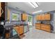 Efficient kitchen featuring modern appliances, a sliding glass door to the exterior, and tiled floors at 4221 Ivy Hill Rd, Raleigh, NC 27616