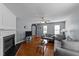 Cozy living room featuring a fireplace, and large windows that provide natural light at 4221 Ivy Hill Rd, Raleigh, NC 27616