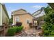 Charming home featuring a stone patio with pergola, lush greenery, and well-manicured landscaping at 4409 All Points View Way, Raleigh, NC 27614