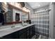 Bathroom featuring double sinks, a large mirror, and a shower with a striped curtain at 4409 All Points View Way, Raleigh, NC 27614