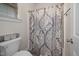 Cozy bathroom featuring patterned shower curtain and storage basket at 4409 All Points View Way, Raleigh, NC 27614