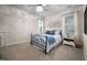 Comfortable bedroom with a metal bed frame, ceiling fan, and soft, neutral colors at 4409 All Points View Way, Raleigh, NC 27614