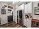 Charming kitchen with stainless steel refrigerator, white cabinets, and wood-look flooring at 4409 All Points View Way, Raleigh, NC 27614