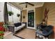 Inviting front porch featuring a swing, ceiling fan, and charming decor at 4409 All Points View Way, Raleigh, NC 27614