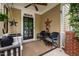 Inviting front porch featuring a swing, ceiling fan, and charming decor at 4409 All Points View Way, Raleigh, NC 27614