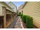 Landscaped side yard with stone pathway, decorative rocks, and a wooden fence at 4409 All Points View Way, Raleigh, NC 27614
