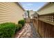Side yard with stone walkway, attractive landscaping, and privacy fence at 4409 All Points View Way, Raleigh, NC 27614