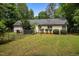 Fenced backyard featuring mature trees, level lawn, a garden, and a home with vinyl siding at 4508 Alice Dr, Oxford, NC 27565