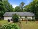 Spacious backyard featuring mature trees, a barbecue, patio, and a well-maintained lawn at 4508 Alice Dr, Oxford, NC 27565