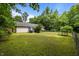 Large backyard with chain link fence, mature trees, a patio with grill and green grass at 4508 Alice Dr, Oxford, NC 27565