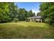 Expansive backyard offers plenty of space for outdoor activities and relaxation surrounded by trees and nature at 4508 Alice Dr, Oxford, NC 27565