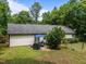 Spacious backyard featuring mature trees, a barbecue, patio, and a well-maintained lawn at 4508 Alice Dr, Oxford, NC 27565
