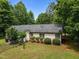 Lawn, fenced backyard featuring mature trees, a garden, and a home with vinyl siding at 4508 Alice Dr, Oxford, NC 27565