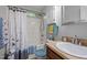 Well-maintained bathroom with tub and shower, cabinet storage, and neutral decor at 4508 Alice Dr, Oxford, NC 27565