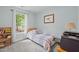 Comfortable bedroom with cozy twin bed, soft carpet, and natural light from the large window at 4508 Alice Dr, Oxford, NC 27565
