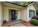 Inviting front entrance with a decorative wreath, potted flowers, and neutral siding at 4508 Alice Dr, Oxford, NC 27565