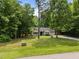 Ranch-style home with well-manicured lawn and a long gravel driveway surrounded by mature trees at 4508 Alice Dr, Oxford, NC 27565