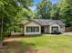 Ranch-style home with green lawn, dark shutters, one-car garage, and mature landscaping at 4508 Alice Dr, Oxford, NC 27565