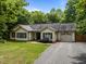 Ranch-style home with green lawn, dark shutters, one-car garage, and mature landscaping at 4508 Alice Dr, Oxford, NC 27565
