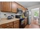 Kitchen featuring wood cabinets, laminate counters, wood-look floors, and stainless steel refrigerator at 4508 Alice Dr, Oxford, NC 27565