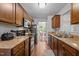Galley kitchen features wood cabinets, laminate counters, wood-look floors, and stainless steel microwave at 4508 Alice Dr, Oxford, NC 27565