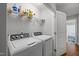 Laundry room features washing machine, dryer, white walls and shelving at 4508 Alice Dr, Oxford, NC 27565