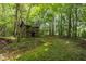 Charming wooded area features a rustic outbuilding surrounded by lush greenery at 4508 Alice Dr, Oxford, NC 27565