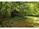 Rustic outbuilding nestled amongst the lush trees, offering plenty of shade and privacy at 4508 Alice Dr, Oxford, NC 27565