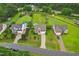 Aerial view of several homes with big yards, long driveways and mature trees, set in a peaceful neighborhood at 50 Consella Way, Franklinton, NC 27525