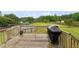 Spacious backyard with an above-ground pool, wooden deck, privacy fence, and a lush green lawn at 50 Consella Way, Franklinton, NC 27525