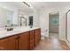 Bright bathroom with double vanity, tile floors and a view to the walk-in shower at 50 Consella Way, Franklinton, NC 27525
